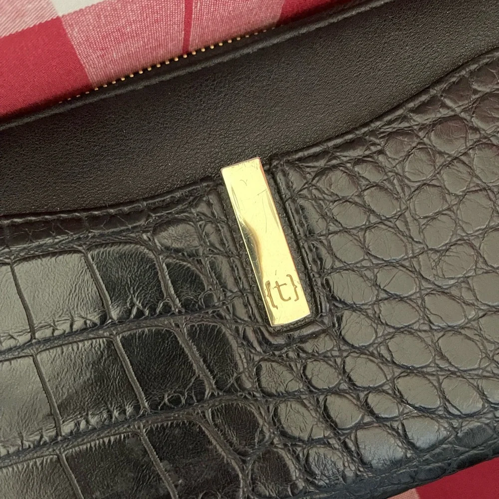 NWOT Tutilo Black wallet with wristlet. Gold hardware. Very nice